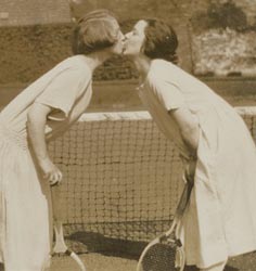 Photograph of two women kissing.