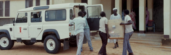 Aid workers loading boxes into a convoy vehicle