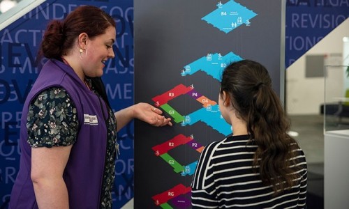 Student interacting with member of Library staff