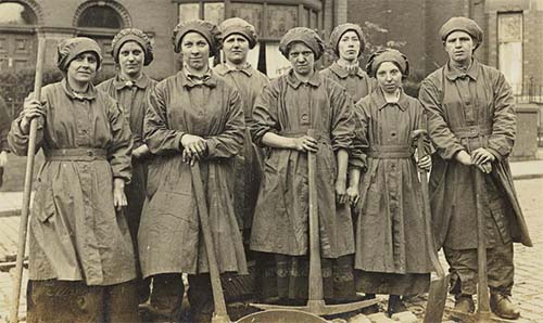 Eight working class women posing in sepia photograph from the collection