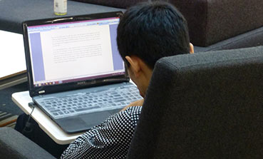 Student using laptop in the library