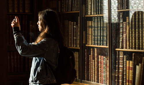 Person taking photograph at The John Rylands Library