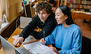 Two students looking at laptop