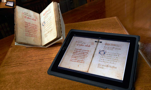 Book from special collections alongside a tablet device