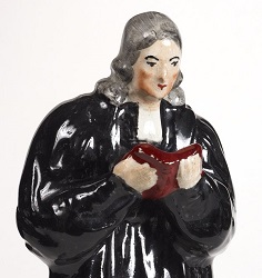 Ceramic figurine of John Wesley preaching in a clerical gown