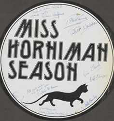 Paper plaque used to advertise the Horniman Festival in celebration of Annie Horniman's work which took place at the Greenwich Theatre, London, during Apr-Jul 1978. Depicts a drawing of a black cat.