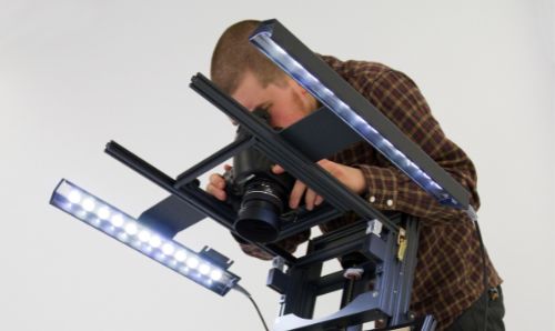 Man using digital camera to photograph an item