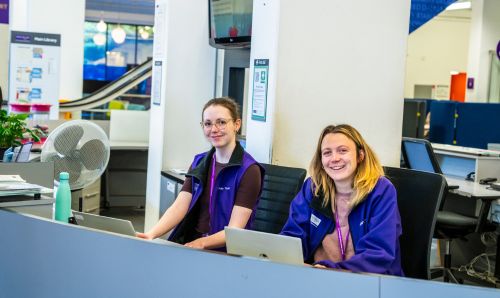 Library Customer Services staff at the desk in Main Library