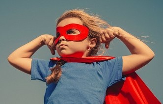 Picture of child dressed as a masked heroine