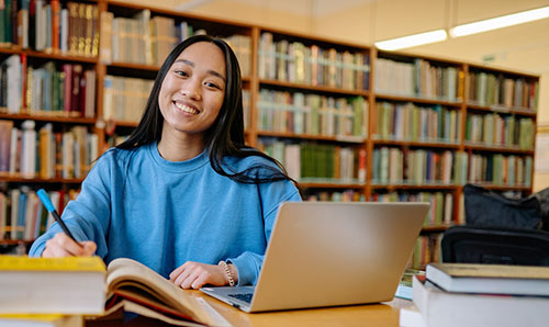 Student in Library smiling