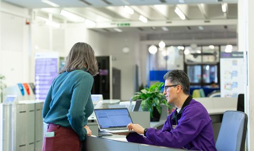 Member of Library staff helping a student